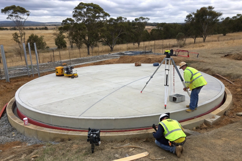 Water tank pad construction with laser levelling equipment Susan River QLD concrete specialist